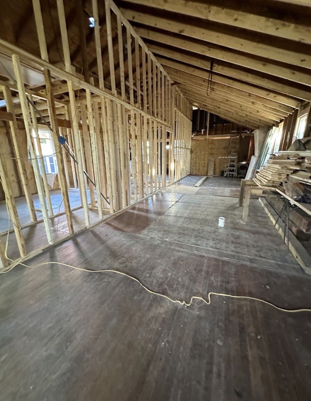 Interior wall framing under an open-rafter ceiling